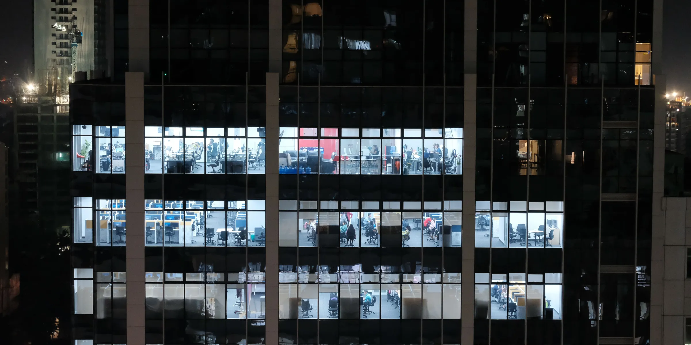 An office building at night with lit floors