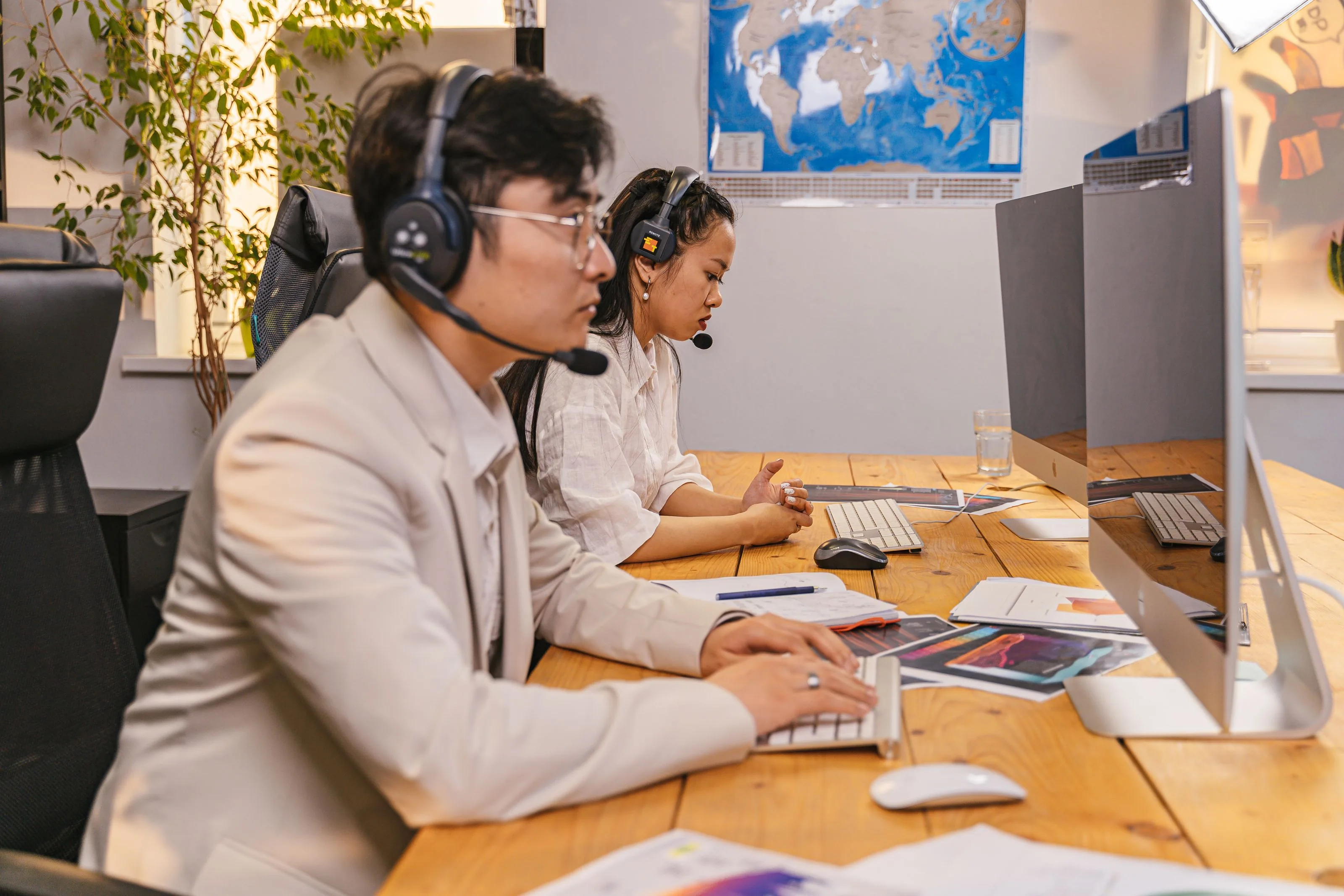 Dealer help desk support team answering customer tickets on computers with headsets
