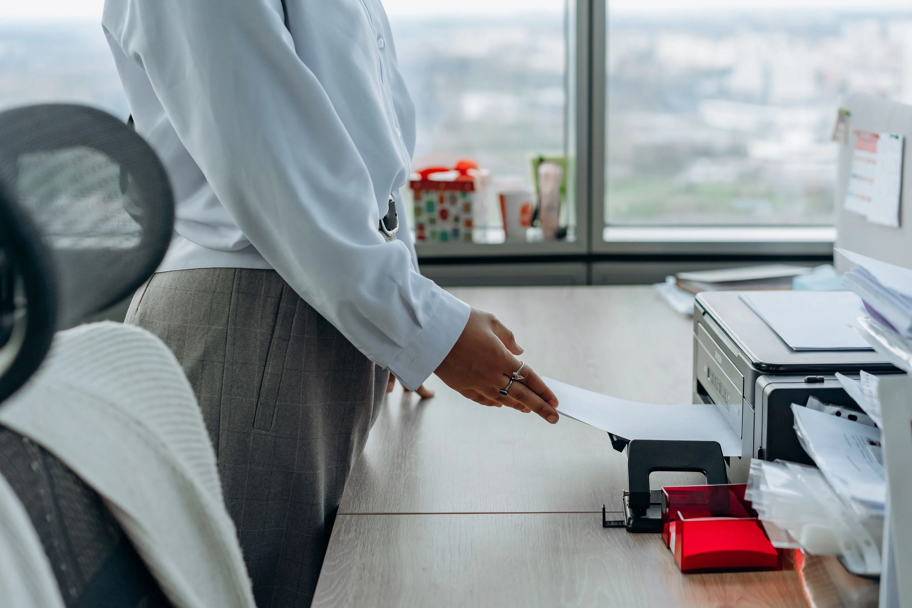 Office worker collecting a printout from a managed office printer
